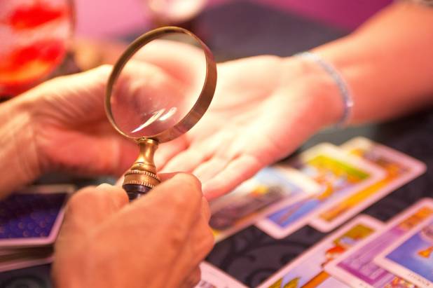 Michelle, who specializes in tarot card and palm reading, uses ...